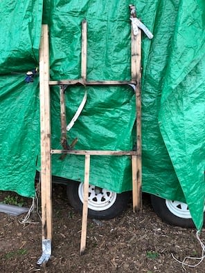 old rotten wooden frame against green tarp